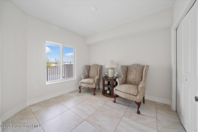 1825 Riverside Dr Unit 205, Titusville, FL 32780 - sitting room featuring baseboards and light tile patterned floors