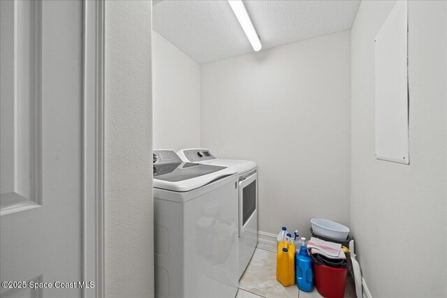 1825 Riverside Dr Unit 205, Titusville, FL 32780 - laundry area featuring washing machine and dryer and a textured ceiling