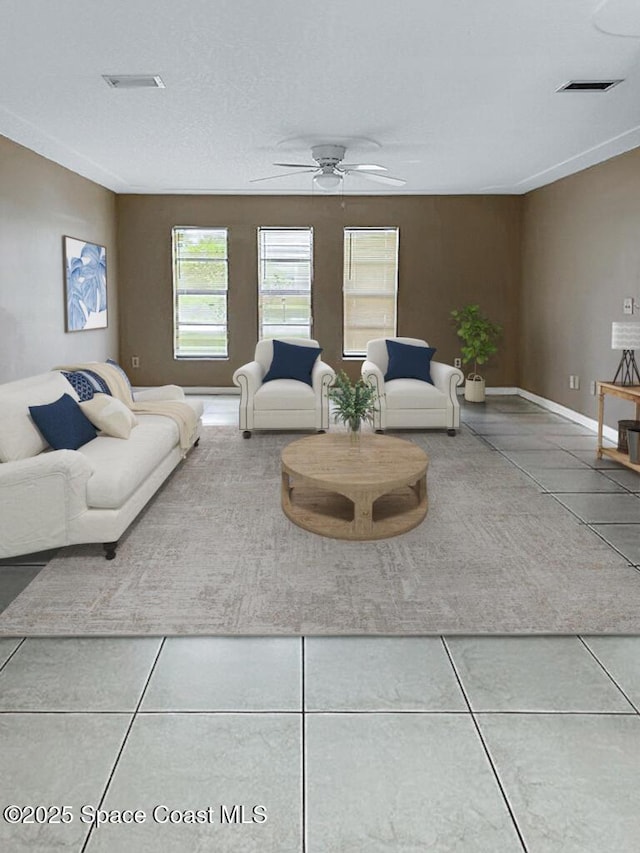 115 Angelo Rd SE, Palm Bay, FL 32909 - living area featuring a ceiling fan, tile patterned floors, and baseboards
