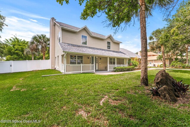 2225 Royal Oaks Dr, Rockledge, FL 32955 - view of front of house with a chimney, a porch, and a shingled roof