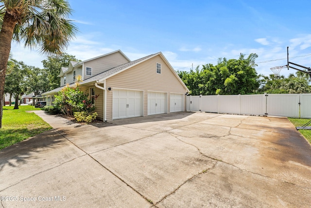 2225 Royal Oaks Dr, Rockledge, FL 32955 - view of home's exterior with a gate, driveway, and a garage