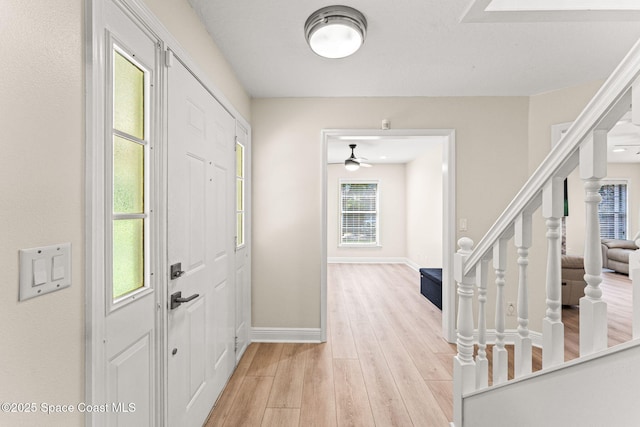 2225 Royal Oaks Dr, Rockledge, FL 32955 - foyer with stairs, light wood-style flooring, a ceiling fan, and baseboards