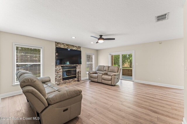 2225 Royal Oaks Dr, Rockledge, FL 32955 - living area with baseboards, light wood finished floors, ceiling fan, a fireplace, and recessed lighting