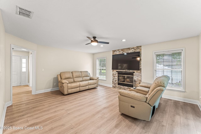 2225 Royal Oaks Dr, Rockledge, FL 32955 - living area featuring baseboards, light wood finished floors, a fireplace, plenty of natural light, and recessed lighting