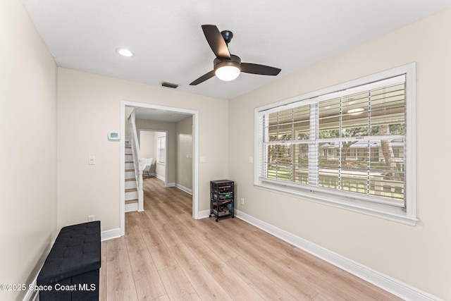 2225 Royal Oaks Dr, Rockledge, FL 32955 - empty room featuring light wood finished floors, a ceiling fan, baseboards, recessed lighting, and stairs