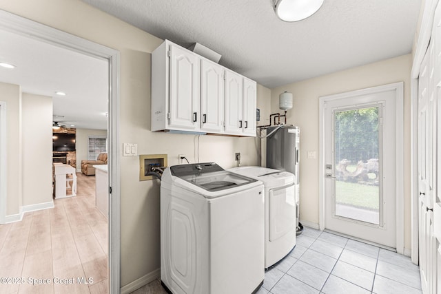 2225 Royal Oaks Dr, Rockledge, FL 32955 - washroom featuring cabinet space, independent washer and dryer, baseboards, and electric water heater