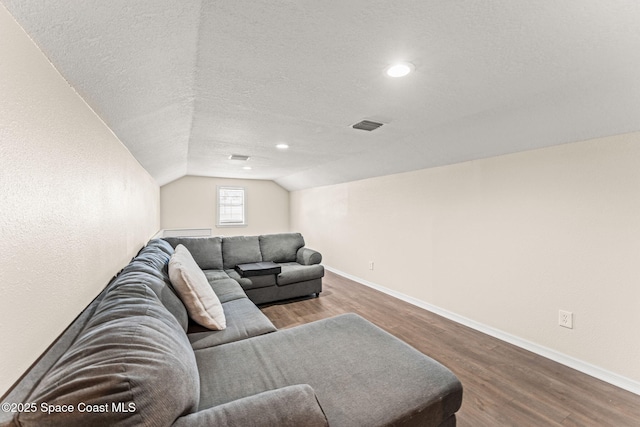 2225 Royal Oaks Dr, Rockledge, FL 32955 - living area with wood finished floors, baseboards, lofted ceiling, recessed lighting, and a textured ceiling