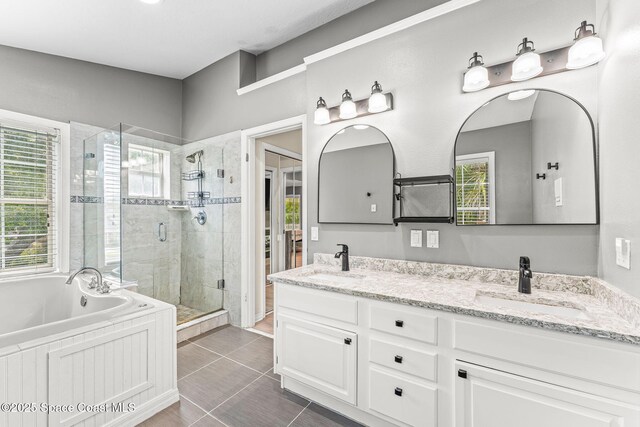 2225 Royal Oaks Dr, Rockledge, FL 32955 - full bathroom with healthy amount of natural light, a shower stall, a garden tub, and double vanity