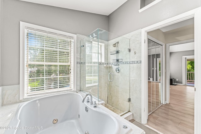 2225 Royal Oaks Dr, Rockledge, FL 32955 - full bath with a shower stall, a tub with jets, and wood finished floors