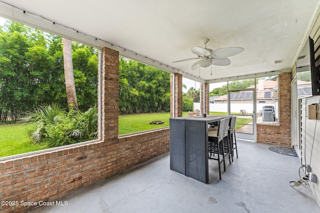 2225 Royal Oaks Dr, Rockledge, FL 32955 - sunroom with ceiling fan and view of wooded area
