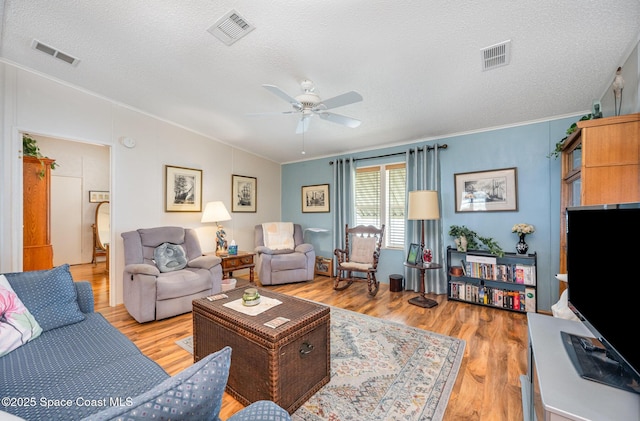 7685 Fox Hunter Cir, Micco, FL 32976 - living room featuring crown molding, light wood finished floors, vaulted ceiling, a textured ceiling, and a ceiling fan