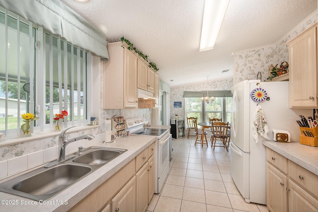 7685 Fox Hunter Cir, Micco, FL 32976 - kitchen with white appliances, wallpapered walls, a sink, light tile patterned floors, and a textured ceiling