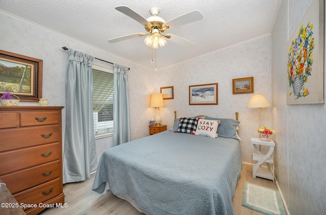 7685 Fox Hunter Cir, Micco, FL 32976 - bedroom featuring light wood-style floors, ornamental molding, a textured ceiling, and a ceiling fan