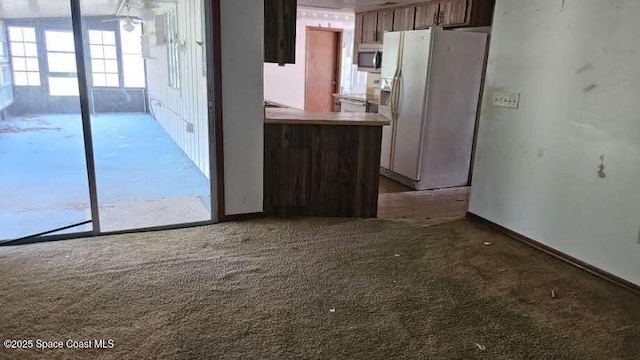 320 Algiers Ave SE, Palm Bay, FL 32909 - kitchen featuring white fridge with ice dispenser, stainless steel microwave, and carpet