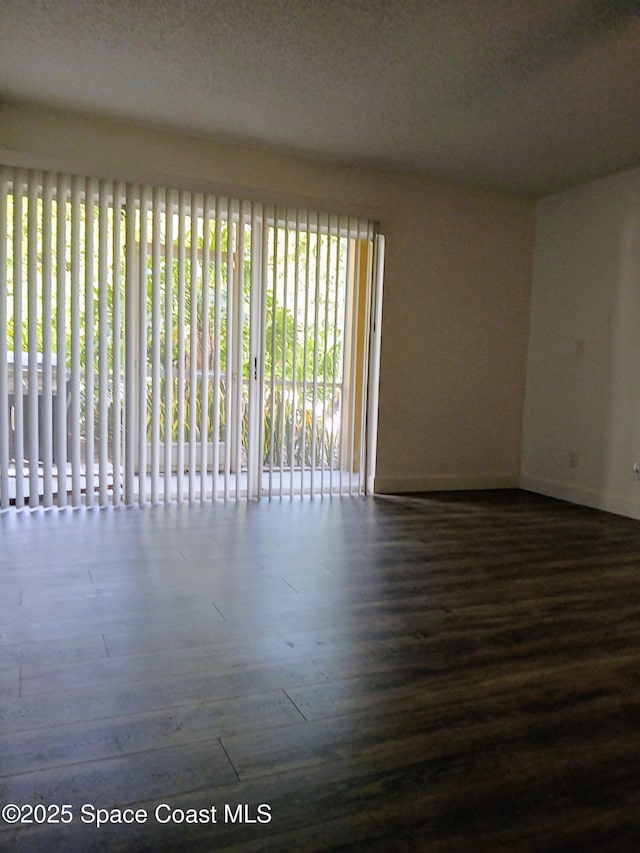 1641 Sunny Brook Ln NE Unit C110, Palm Bay, FL 32905 - empty room featuring dark wood-style flooring and baseboards