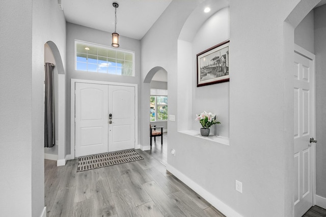 382 Eldron Blvd NE, Palm Bay, FL 32907 - entrance foyer featuring arched walkways, wood finished floors, and baseboards