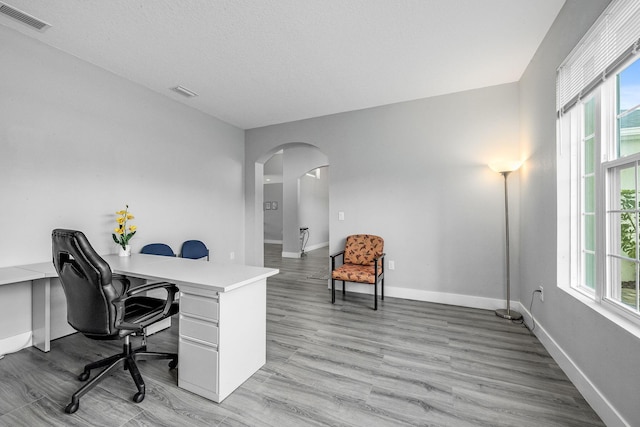 382 Eldron Blvd NE, Palm Bay, FL 32907 - office space featuring arched walkways, baseboards, and light wood-style flooring