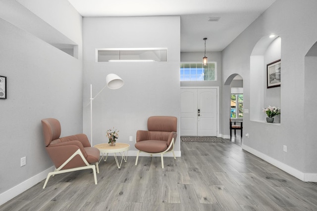 382 Eldron Blvd NE, Palm Bay, FL 32907 - entryway featuring arched walkways, wood finished floors, baseboards, and a towering ceiling