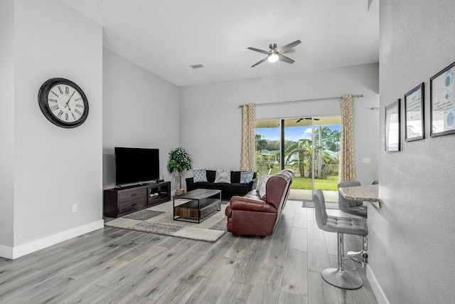 382 Eldron Blvd NE, Palm Bay, FL 32907 - living room with a ceiling fan, light wood-style floors, and baseboards