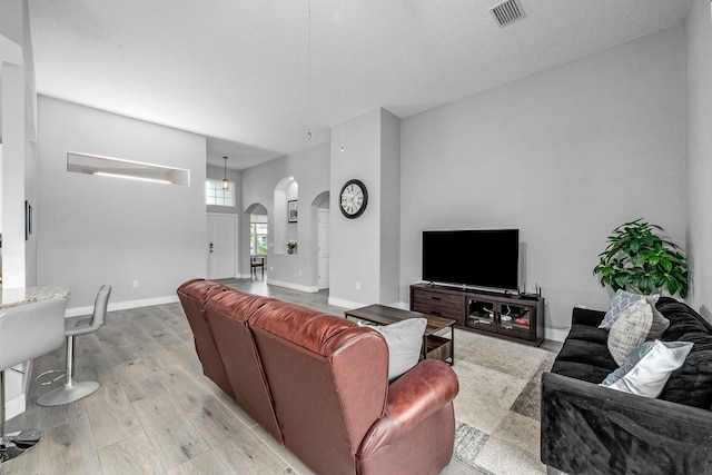 382 Eldron Blvd NE, Palm Bay, FL 32907 - living area with arched walkways, light wood-type flooring, and baseboards