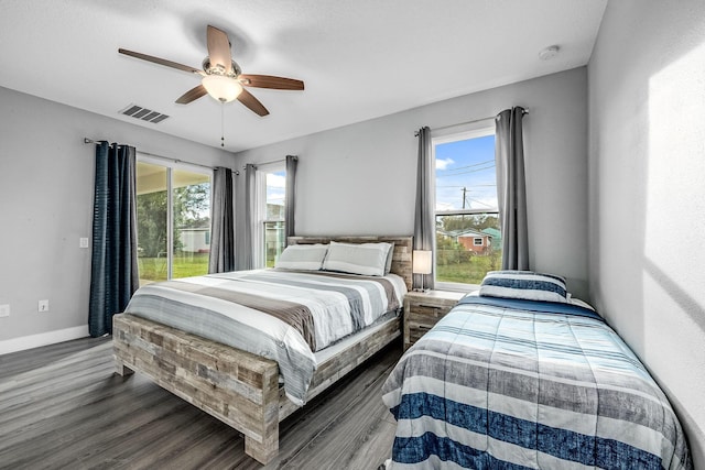 382 Eldron Blvd NE, Palm Bay, FL 32907 - bedroom featuring dark wood-type flooring, a ceiling fan, baseboards, and access to exterior