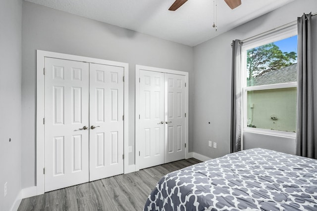 382 Eldron Blvd NE, Palm Bay, FL 32907 - bedroom with wood finished floors, two closets, baseboards, and a ceiling fan