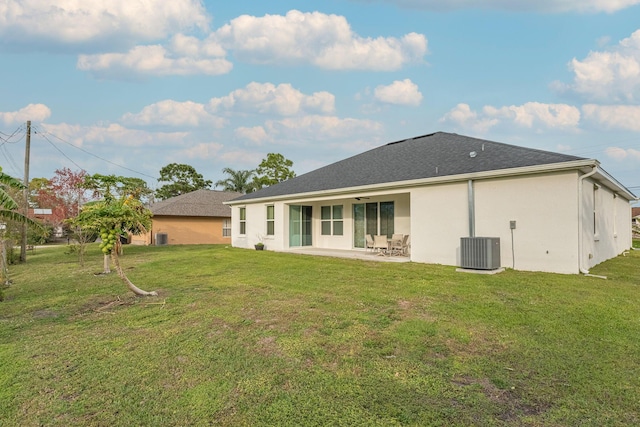 382 Eldron Blvd NE, Palm Bay, FL 32907 - rear view of house with central air condition unit, a patio, a lawn, and stucco siding