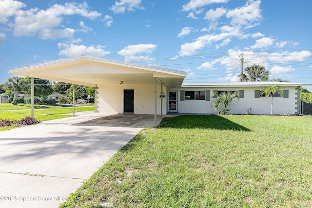 2885 Fountainhead Blvd, Melbourne, FL 32935 - single story home featuring driveway, an attached carport, a front yard, and stucco siding