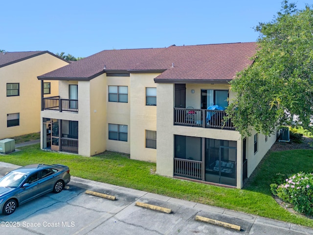 5630 N Banana River Blvd Unit 1, Cocoa Beach, FL 32931 - view of building exterior featuring uncovered parking
