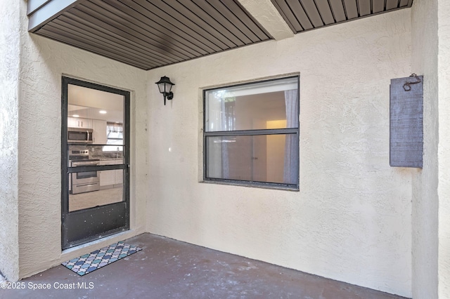 5630 N Banana River Blvd Unit 1, Cocoa Beach, FL 32931 - view of exterior entry featuring stucco siding