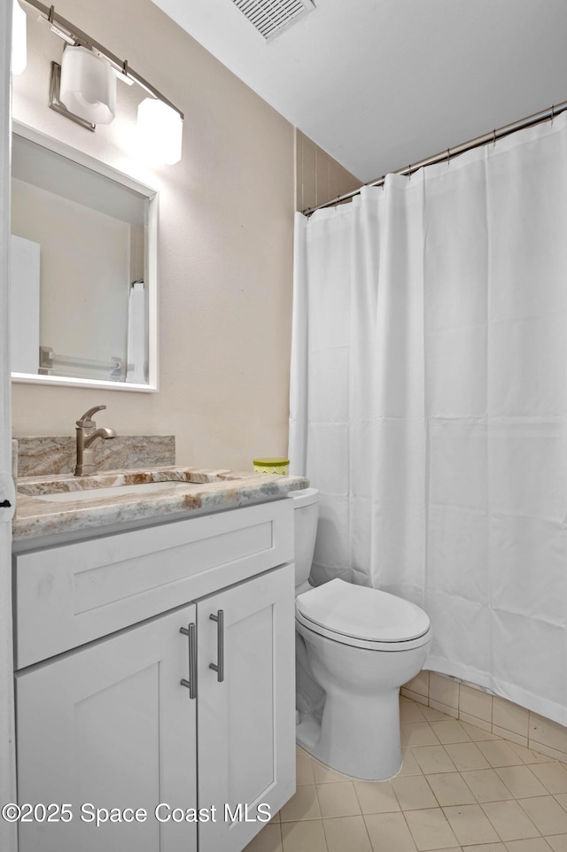 5630 N Banana River Blvd Unit 1, Cocoa Beach, FL 32931 - bathroom with toilet, vanity, and tile patterned flooring