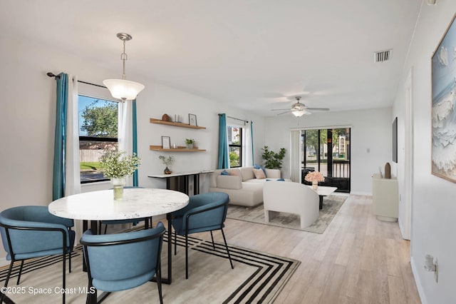 5630 N Banana River Blvd Unit 1, Cocoa Beach, FL 32931 - dining area featuring light wood finished floors and ceiling fan