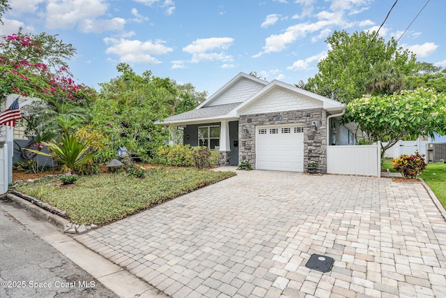 210 Sutton St, Rockledge, FL 32955 - view of front facade with decorative driveway, stone siding, and an attached garage