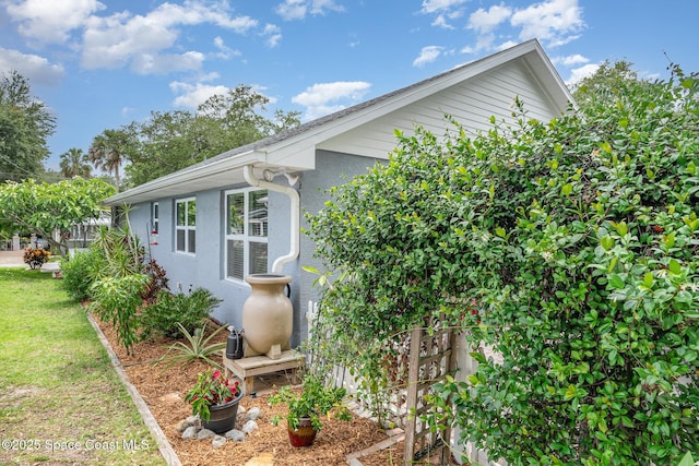 210 Sutton St, Rockledge, FL 32955 - view of side of property with stucco siding