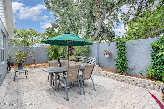 210 Sutton St, Rockledge, FL 32955 - fenced backyard featuring outdoor dining area and a patio