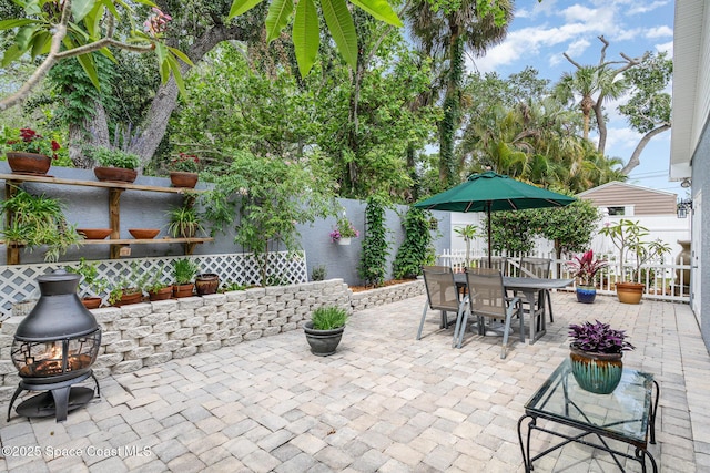 210 Sutton St, Rockledge, FL 32955 - fenced backyard featuring a patio area, a fire pit, and outdoor dining area