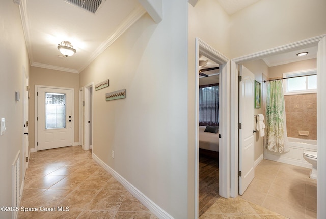 210 Sutton St, Rockledge, FL 32955 - foyer with ornamental molding, light tile patterned flooring, and baseboards