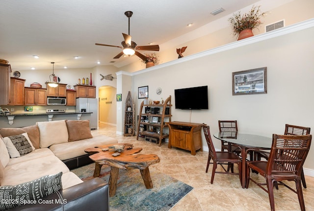 210 Sutton St, Rockledge, FL 32955 - living room with arched walkways, a ceiling fan, baseboards, lofted ceiling, and recessed lighting