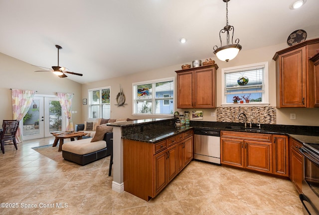 210 Sutton St, Rockledge, FL 32955 - kitchen with appliances with stainless steel finishes, a sink, lofted ceiling, brown cabinets, and open floor plan