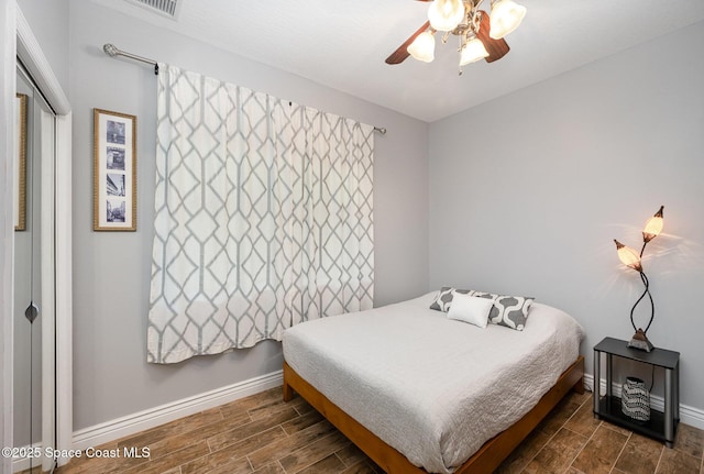 210 Sutton St, Rockledge, FL 32955 - bedroom with dark wood finished floors, baseboards, and ceiling fan