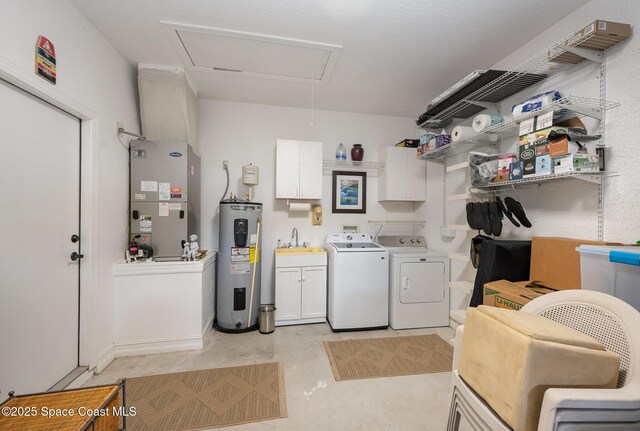 210 Sutton St, Rockledge, FL 32955 - washroom with electric water heater, cabinet space, independent washer and dryer, attic access, and heating unit