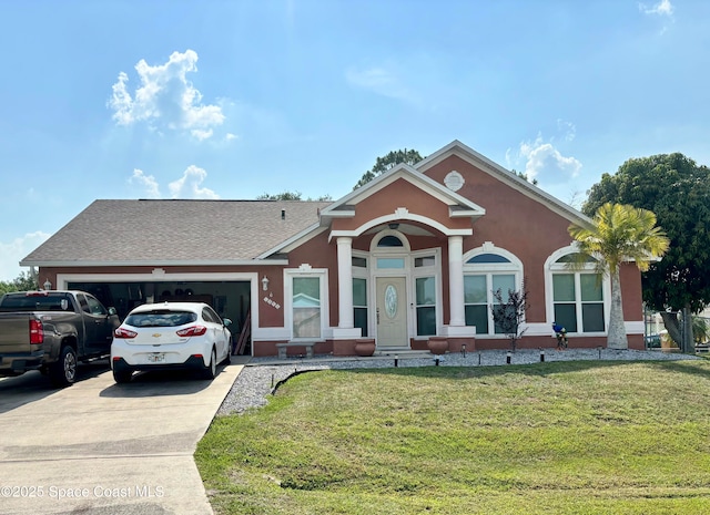 1398 Stuttgart Ave NW, Palm Bay, FL 32907 - view of front of home featuring an attached garage, driveway, a front yard, stucco siding, and roof with shingles
