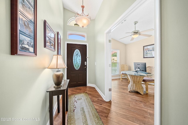 1398 Stuttgart Ave NW, Palm Bay, FL 32907 - foyer entrance with vaulted ceiling, wood finished floors, baseboards, and a ceiling fan