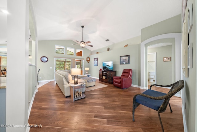 1398 Stuttgart Ave NW, Palm Bay, FL 32907 - living room featuring arched walkways, ceiling fan, vaulted ceiling, wood finished floors, and baseboards