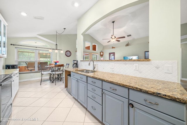 1398 Stuttgart Ave NW, Palm Bay, FL 32907 - kitchen featuring a sink, ceiling fan, lofted ceiling, decorative backsplash, and light tile patterned floors
