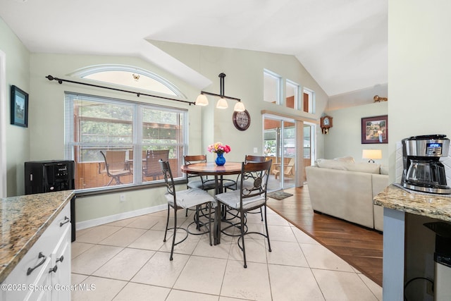 1398 Stuttgart Ave NW, Palm Bay, FL 32907 - dining space featuring lofted ceiling, healthy amount of natural light, and light tile patterned floors