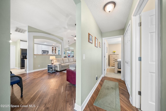 1398 Stuttgart Ave NW, Palm Bay, FL 32907 - corridor with hardwood / wood-style floors, baseboards, and arched walkways
