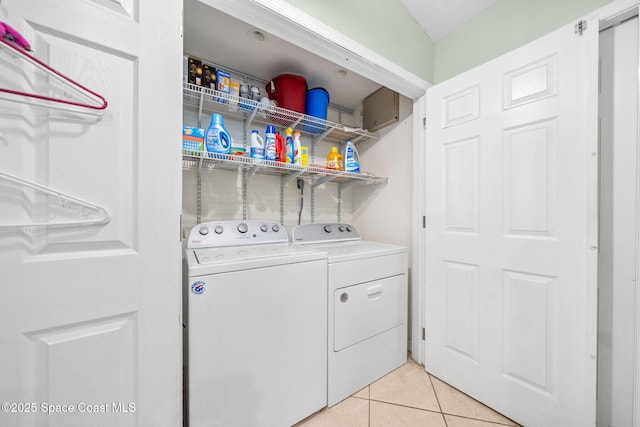 1398 Stuttgart Ave NW, Palm Bay, FL 32907 - laundry room featuring washer and dryer and light tile patterned flooring
