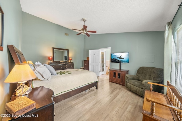 1398 Stuttgart Ave NW, Palm Bay, FL 32907 - bedroom featuring wood finished floors, a textured ceiling, a ceiling fan, and vaulted ceiling