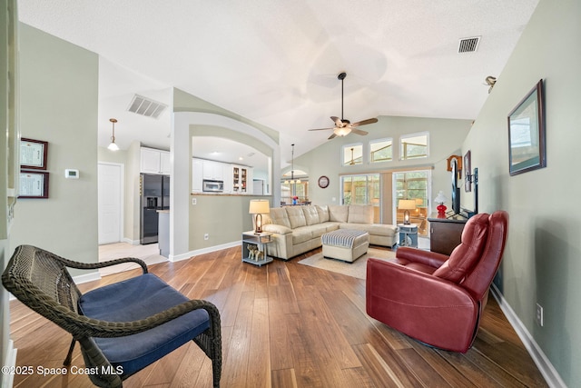 1398 Stuttgart Ave NW, Palm Bay, FL 32907 - living room with vaulted ceiling, ceiling fan, light wood-style flooring, baseboards, and arched walkways